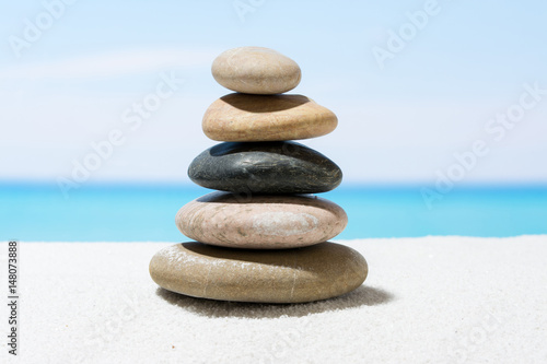 Relaxing in the tropical beach, with white sand and stack of stones