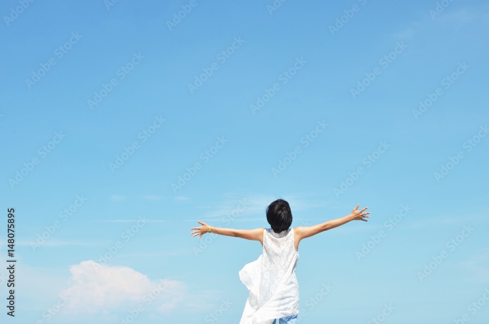 Asian woman feels happy with blue sky background Asian woman feels happy with blue sky background