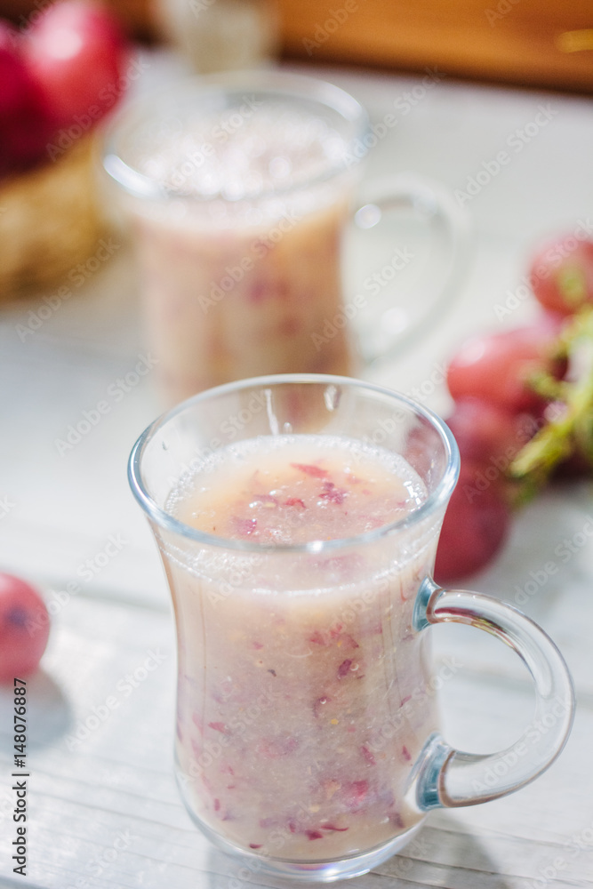 Grape smoothie over the white table. Grape smoothie over the white table.