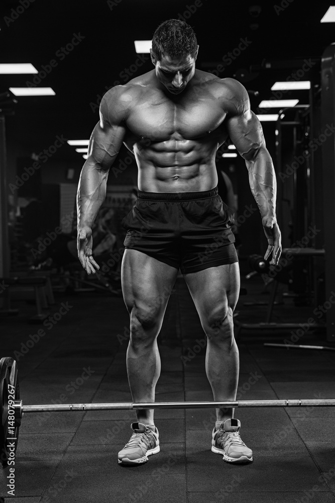 Brutal strong athletic men pumping up muscles workout bodybuilding concept background - muscular bodybuilder handsome men doing exercises in gym Brutal strong athletic men pumping up muscles workout bodybuilding concept background - muscular bodybuilder handsome men doing exercises in gym