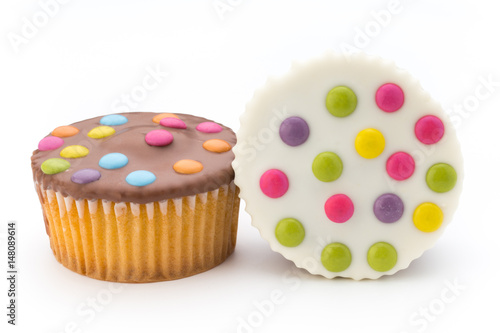 Multiple colorful decorated muffins on a white background.