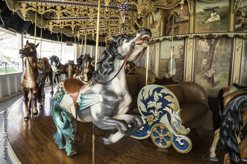 Fototapeta Naklejka Na Ścianę i Meble -  Vintage restored carousel hand carved wooden seahorse on a merry go round ride