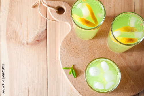Lemonade glasses with lemon, mint and ice. Top view with copy space