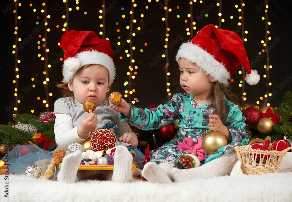 child girl portrait in christmas decoration, happy emotions, winter holiday concept, dark background with illumination and boke lights