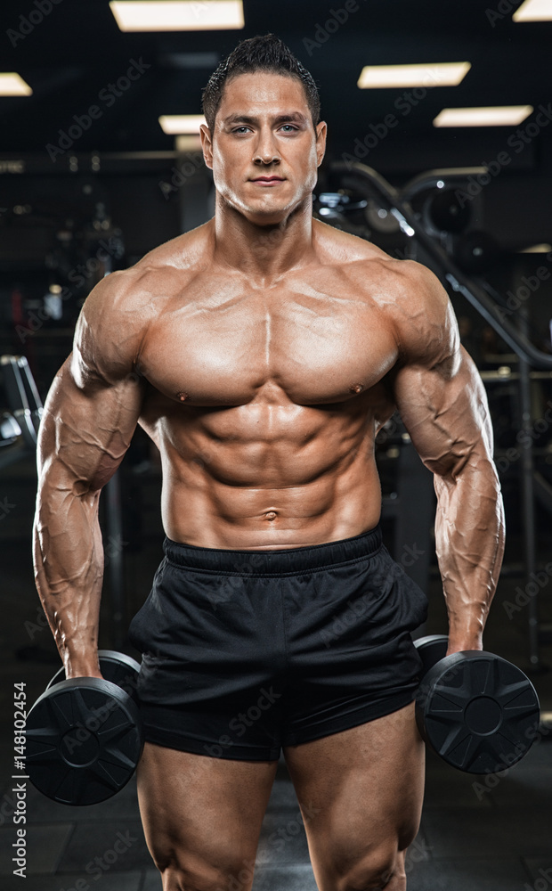 Brutal strong athletic men pumping up muscles workout bodybuilding concept background - muscular bodybuilder handsome men doing exercises in gym