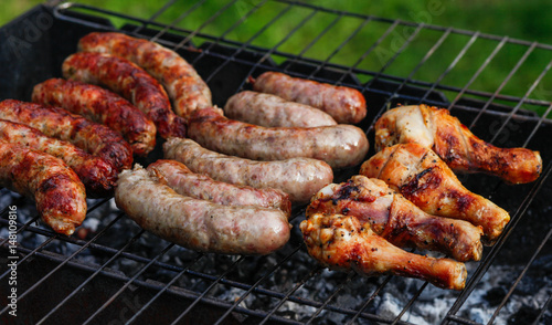 Cook out. Sausages and chicken on grill