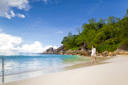 A beautiful woman walking on the beach photo