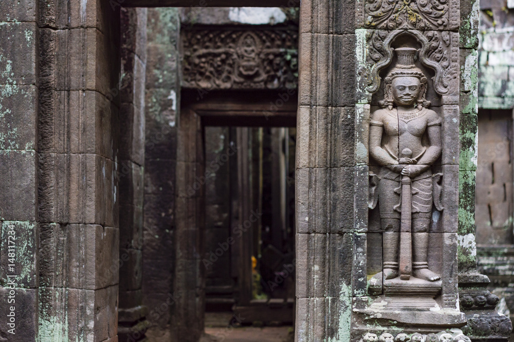 Carved in stone sculptures on the facade of Vat Phou (or Wat Phu) - Khmer Hindu temple complex in Champasak Province, southern Laos