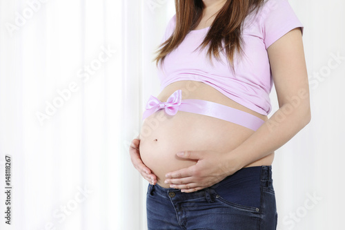 pregnant belly with pink bow, isolated on white background Free Download pregnant belly with pink bow, isolated on white background - GFXLoad