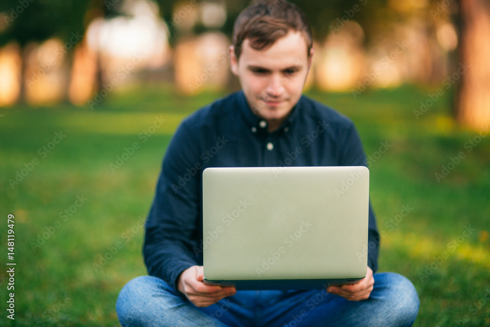 The young manager working on a laptop in the park. Lunch Break. The young manager working on a laptop in the park. Lunch Break.