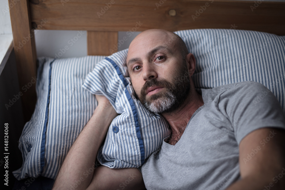 Fototapeta premium Mid forties depressed man in bed at home