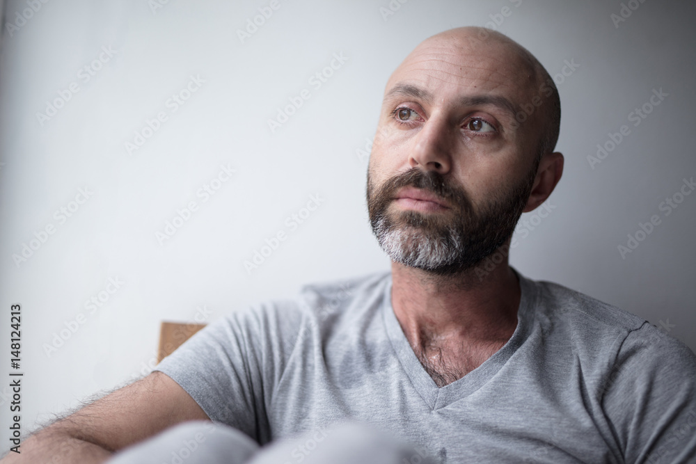 Mid forties depressed man in bed at home Mid forties depressed man in bed at home