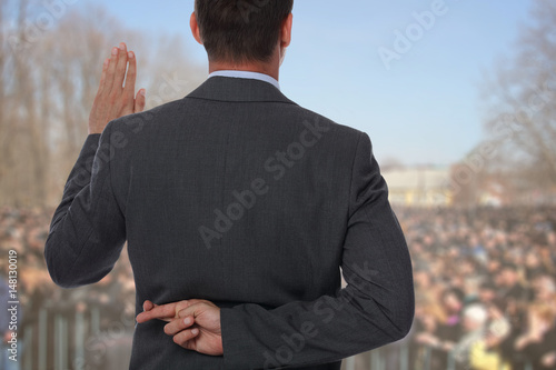 Fényképezés Politician liar gives people impossible promises with fingers crossed on his back