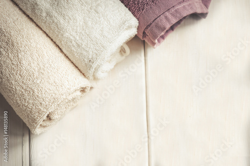 Towels over white wooden background. Spa products