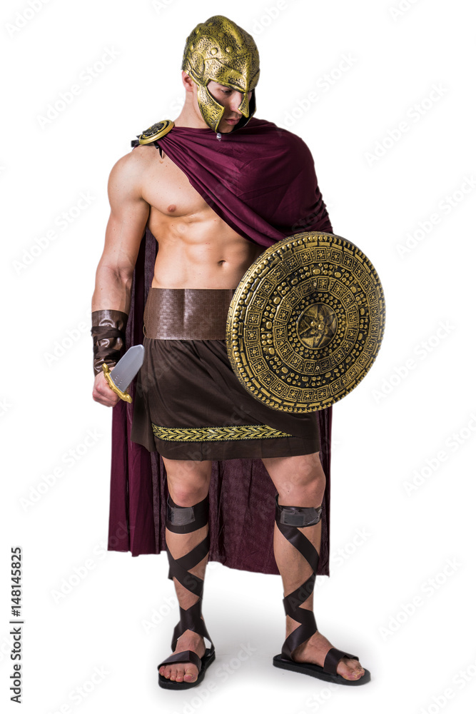 Young handsome muscular man posing in roman or spartan gladiator costume  with shield and sword, standing isolated on white background in studio  Stock Photo | Adobe Stock