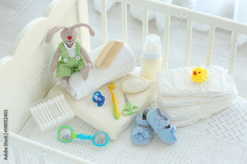 Fototapeta Naklejka Na Ścianę i Meble -  Set of baby accessories for hygiene in crib
