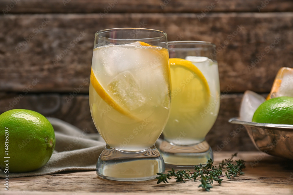 Refreshing cocktails with lemon on wooden table Refreshing cocktails with lemon on wooden table