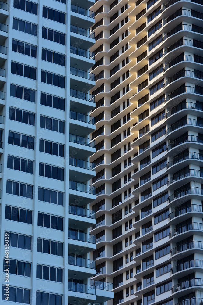 Exterior walls of tall apartment buildings covered with windows and balconies. Exterior walls of tall apartment buildings covered with windows and balconies.