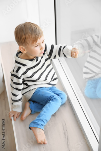 Cute little boy sitting on ...