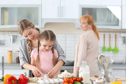 Young woman, her daughter a...