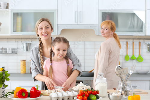 Young woman, her daughter a...