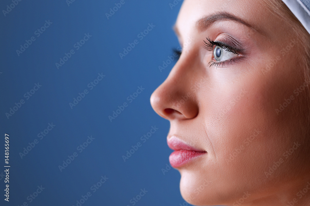 A beautiful woman, portrait isolated on blue background A beautiful woman, portrait isolated on blue background
