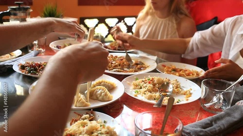 Friends eat Chinese food in a Chinese restaurant