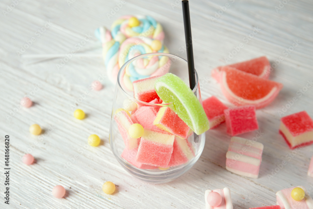 Composition with tasty candies on light wooden background Composition with tasty candies on light wooden background