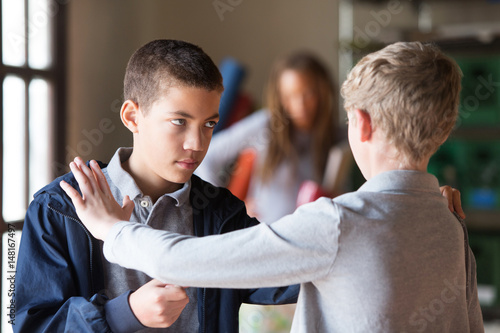 Students fighting indoors photo