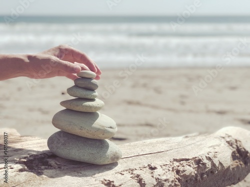 Stack of zen stones on the sea beach.