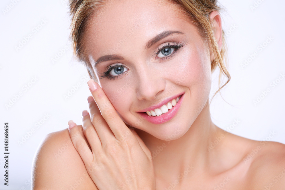 Young woman touching her face isolated on white background Young woman touching her face isolated on white background
