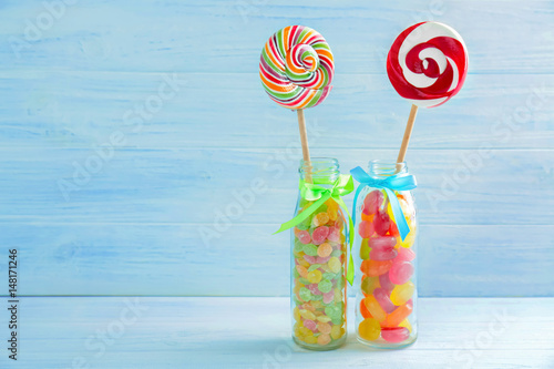 Composition of different candies on wooden background
