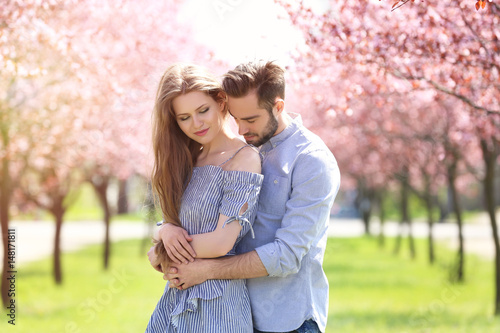 Young lovely couple walking in spring park © Africa Studio