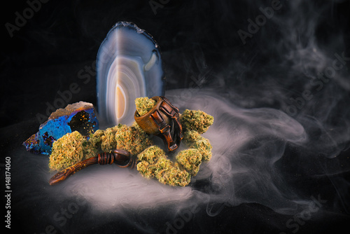 Detail of cannabis buds (Zed strain) isolated over black background with smoke photo