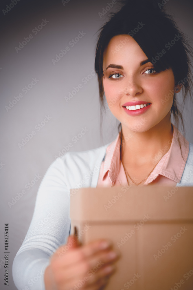 Portrait of pretty woman holding a box