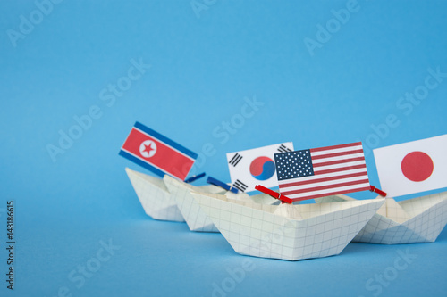 paper ship with Flags of USA, China, North Korea, South Korea, Japan And other East Asian countries 