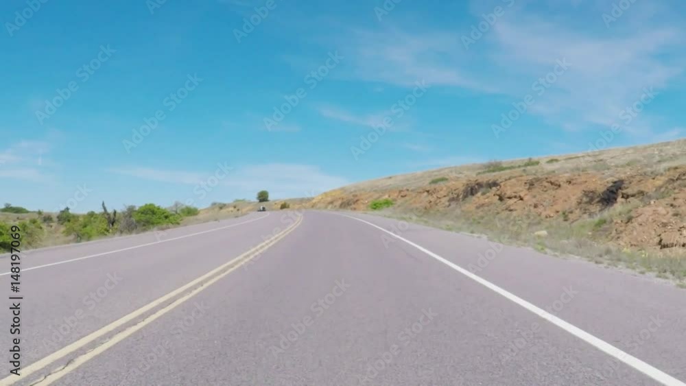 Wichita Mountains Wildlife Refuge. Oklahoma, USA - April 8, 2017. POV. Point of view - driving through Wildlife Refuge. Open prairie with mountains in the background. Wichita Mountains Wildlife Refuge. Oklahoma, USA - April 8, 2017. POV. Point of view - driving through Wildlife Refuge. Open prairie with mountains in the background.