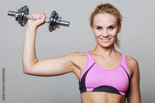 Fit woman lifting dumbbells weights