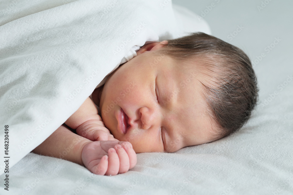 Asian newborn sleeping under white blanket, asian baby portrait cute Asian newborn sleeping under white blanket, asian baby portrait cute