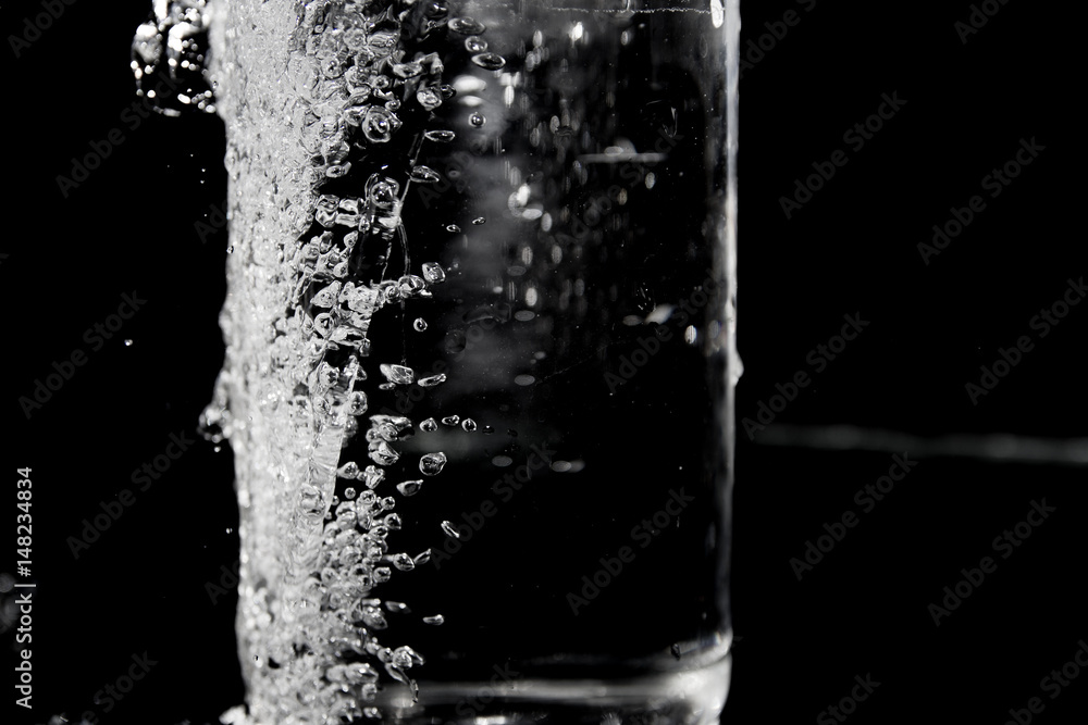 Splash of water on black, Stylish water splash. Isolated on black background, bubbles in the glass,