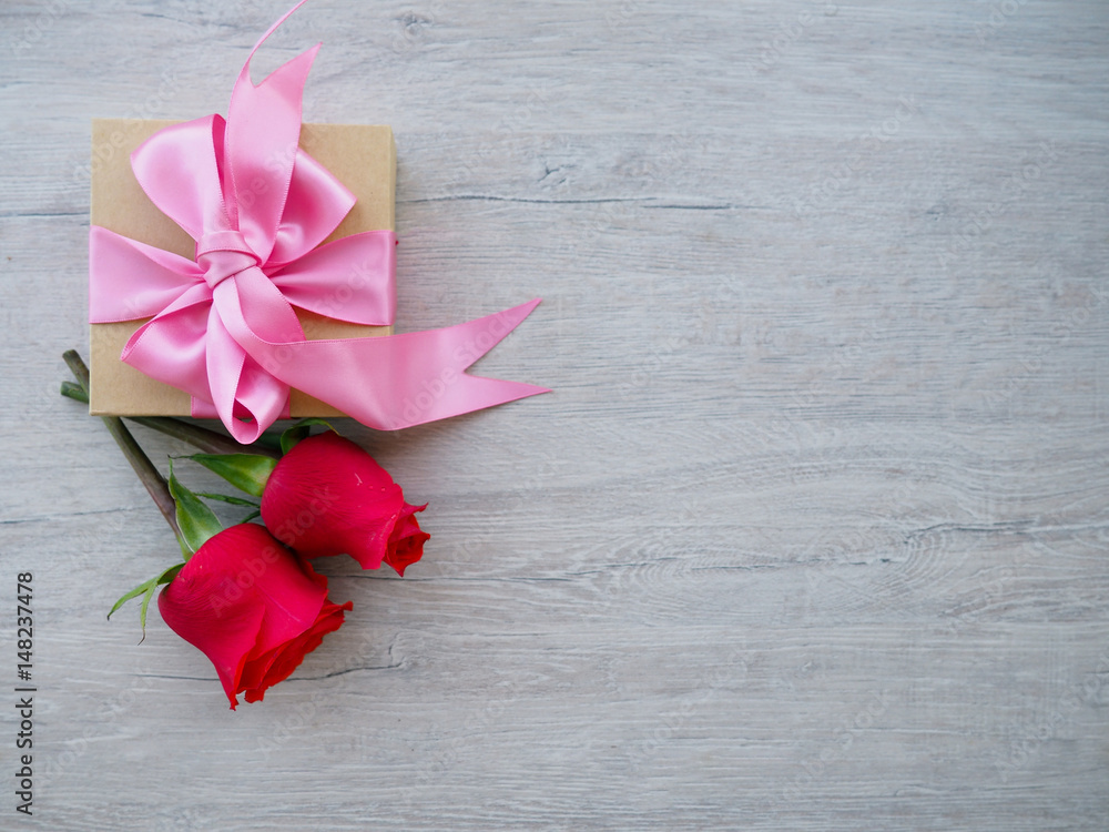 gentle sweet composition for Valentine's day, birthday, wedding in pink and red colors, little red heart box gift with pink bow, top view.