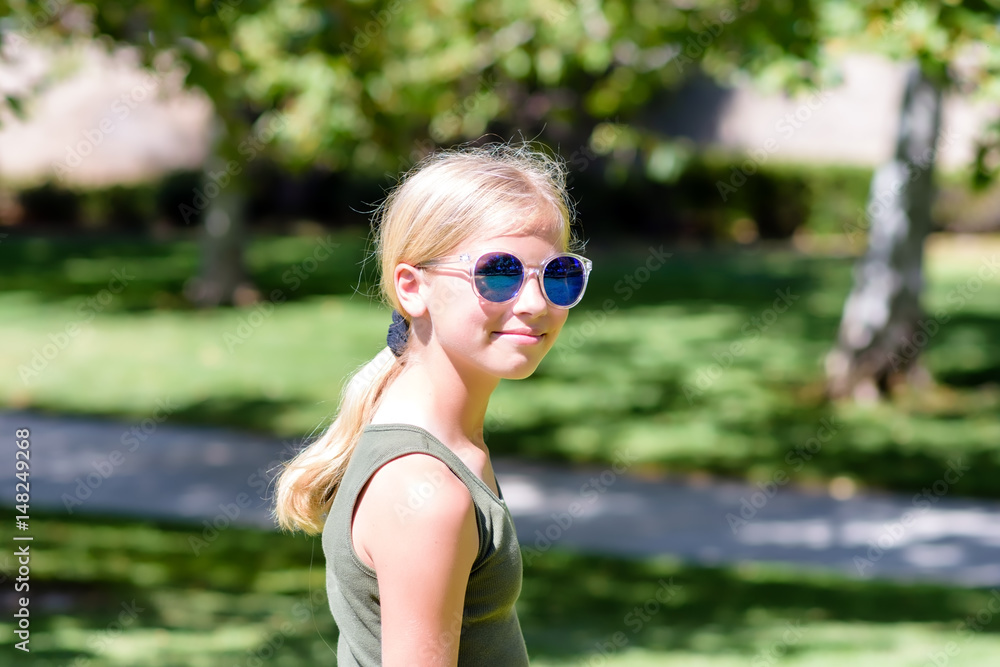Young female walks in the park on sunny day Young female walks in the park on sunny day