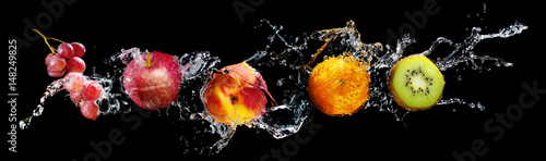 Set of fresh fruits in water splash isolated on black background