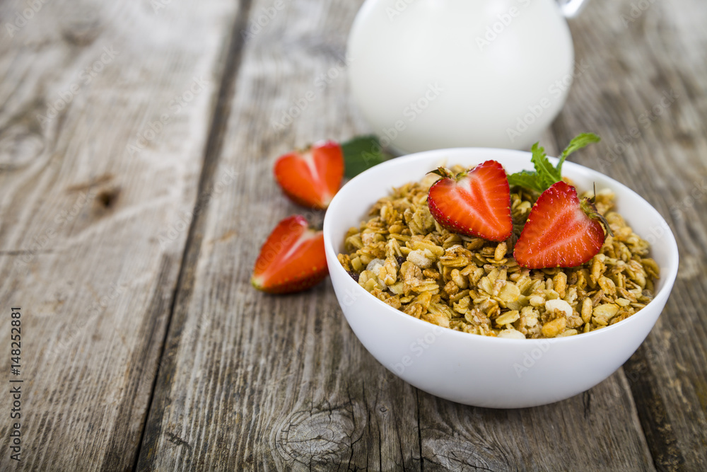 Granola with strawberry on a wooden table. Granola with strawberry on a wooden table.