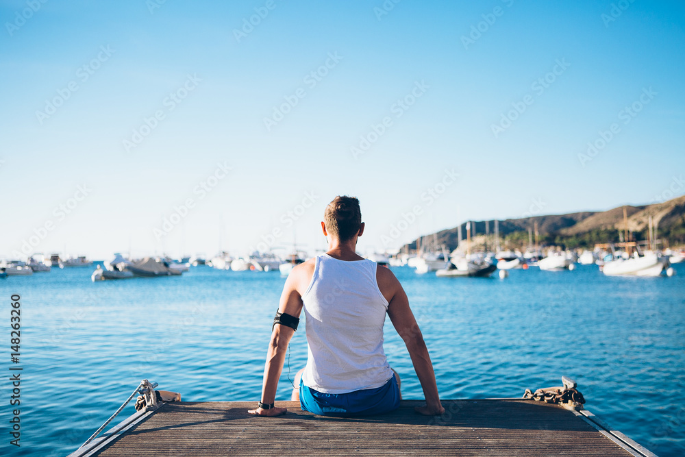 Fit man relaxing on pier