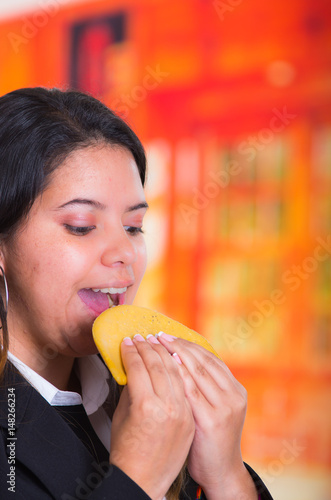 Gorgeous woman eating a tortilla  traditional andean food concept