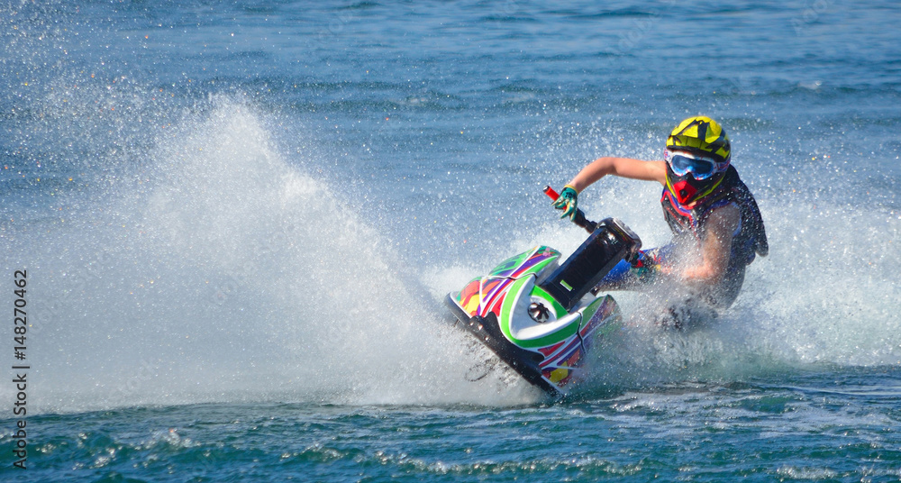 Jet Ski competitor cornering at speed creating at lot of spray. Jet Ski competitor cornering at speed creating at lot of spray.