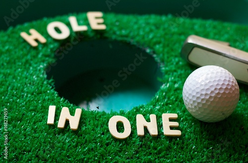 Hole in one on green grass photo