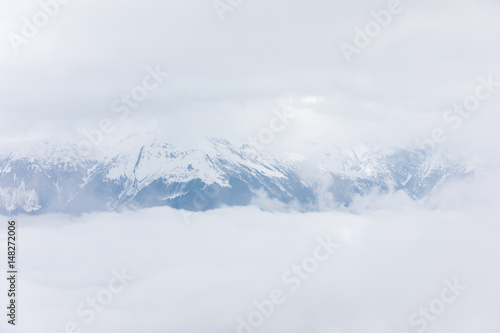 Mountains covered with snow in the clouds