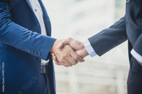 Businessman shake hand together, agreement business concept, vintage color tone photo